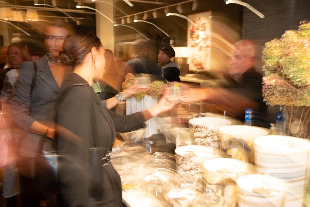 Guests gathering at the bar inside HW Home